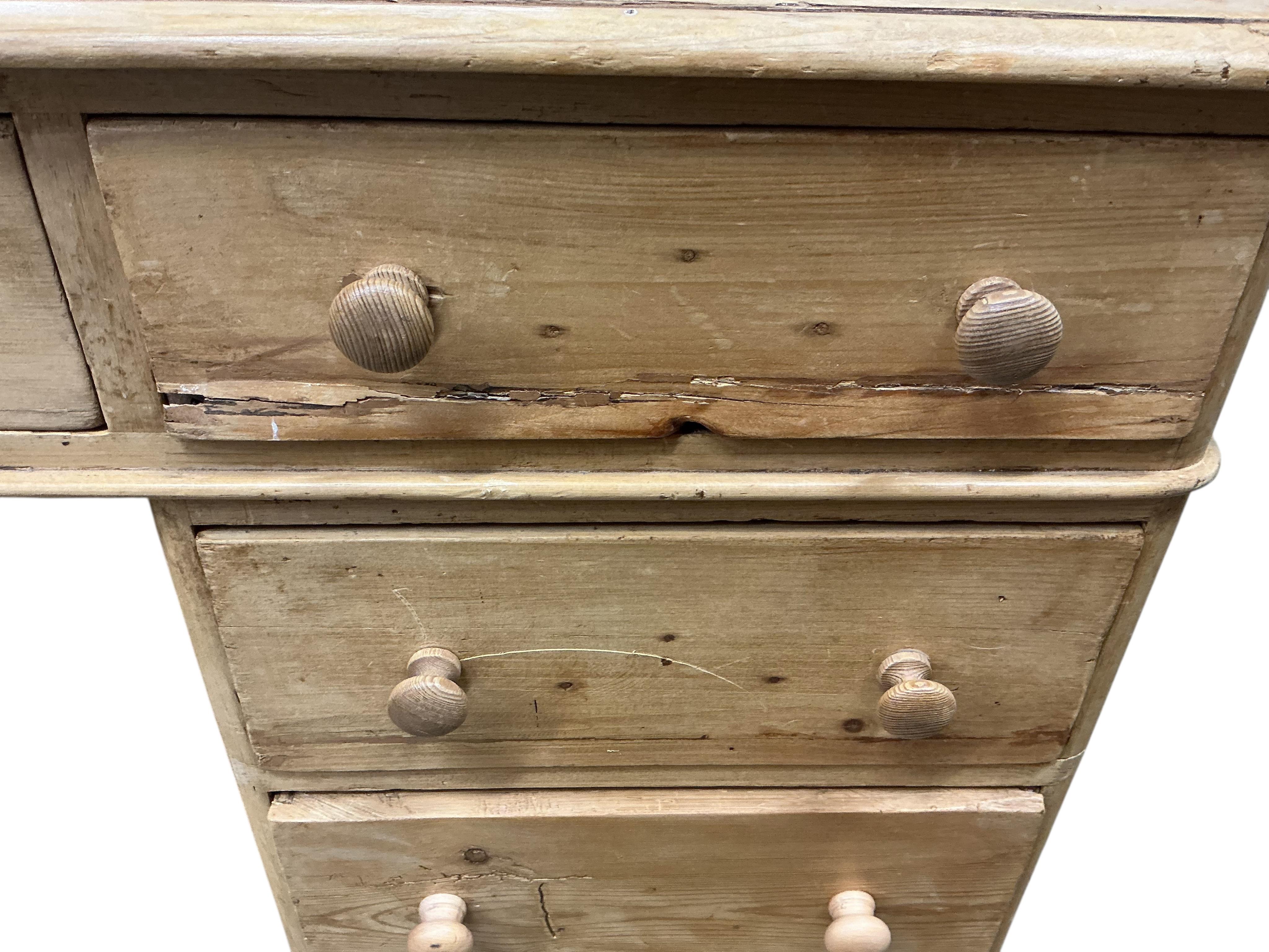 A Victorian pine pedestal desk, fitted with nine small drawers, width 122cm, depth 54cm, height 82cm